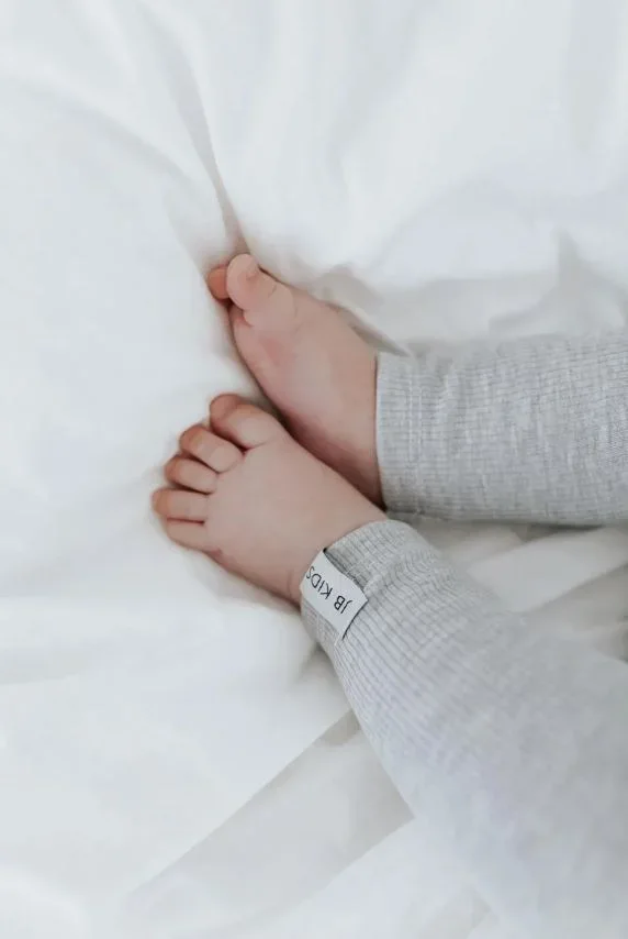 Nahaufnahme der elastischen Ripp-Struktur und J&B Kids Label an der grauen Kinderhose